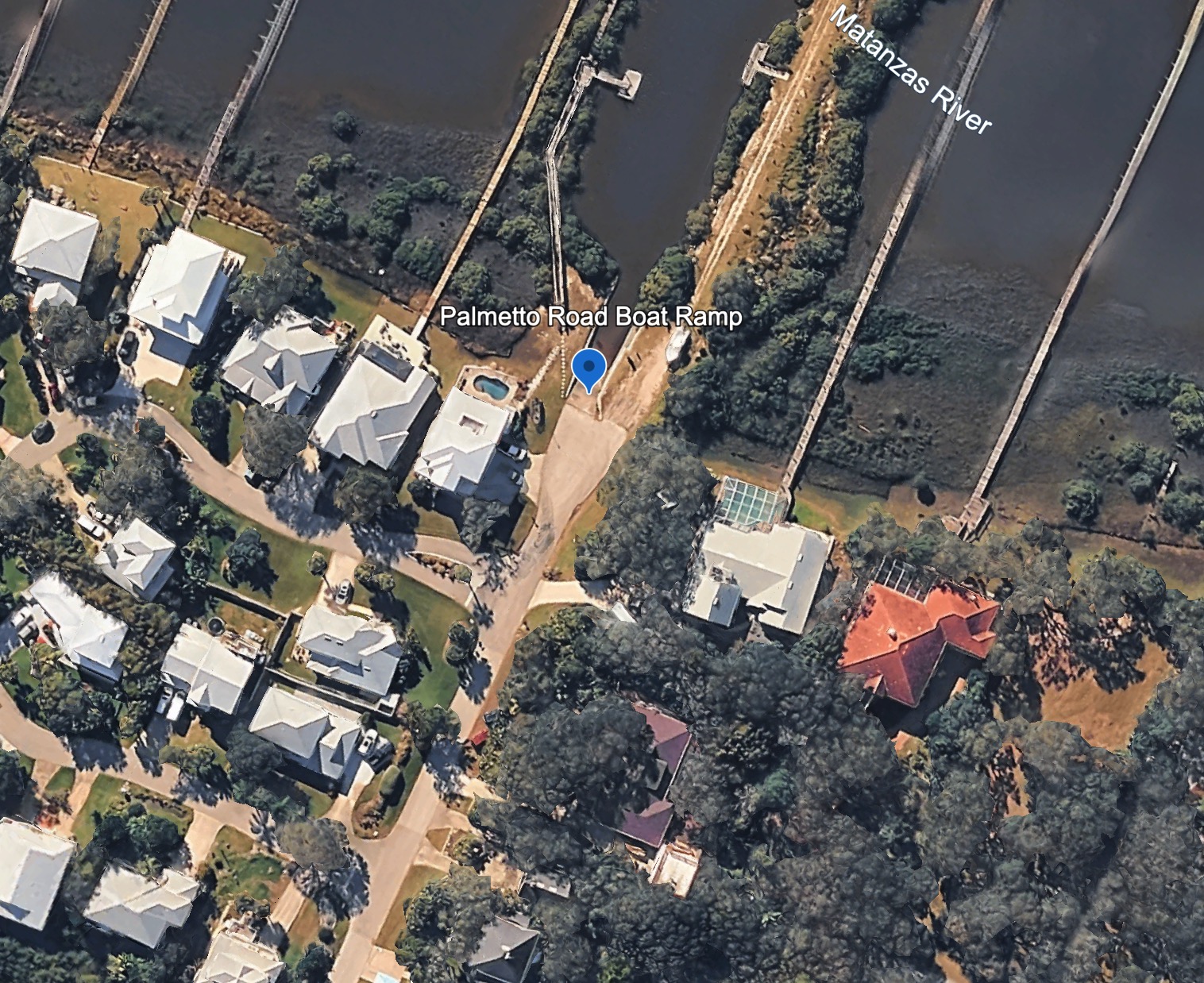 Aerial satellite view of the Palmetto Road Boat Ramp at the Matanzas River, with neighboring homes and private docks.